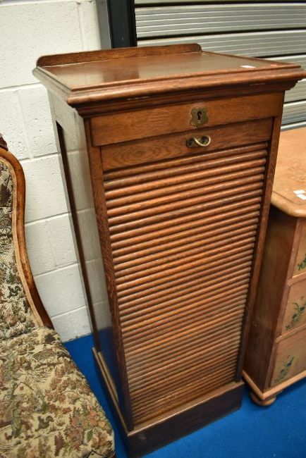 Tambour front oak music or office cabinet sold at 1818 auctioneers in a timed auction of furniture and furnishings