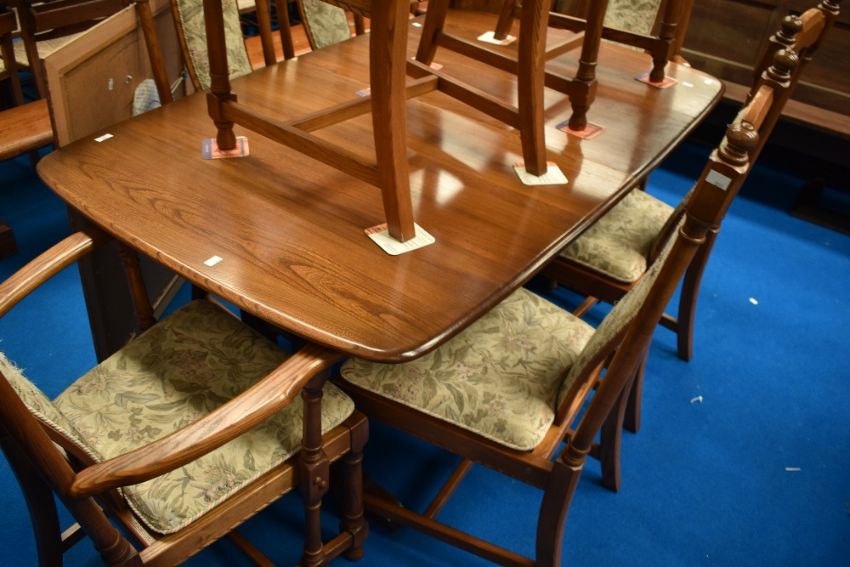 An Ercol extending dining table and eight (six plus two chairs) sold at 1818 Auctioneers in their online furniture and furnishings auction